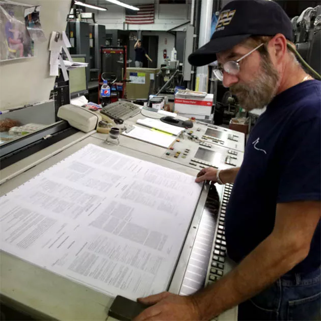 Commercial Printer Reviewing Proofs for Client Commercial Printer Reviewing Proofs for Client